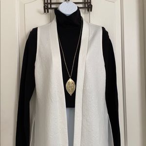 White long-lined sleeveless vest